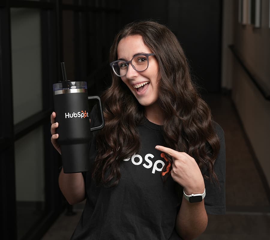 Sarah headshot with HubSpot merch