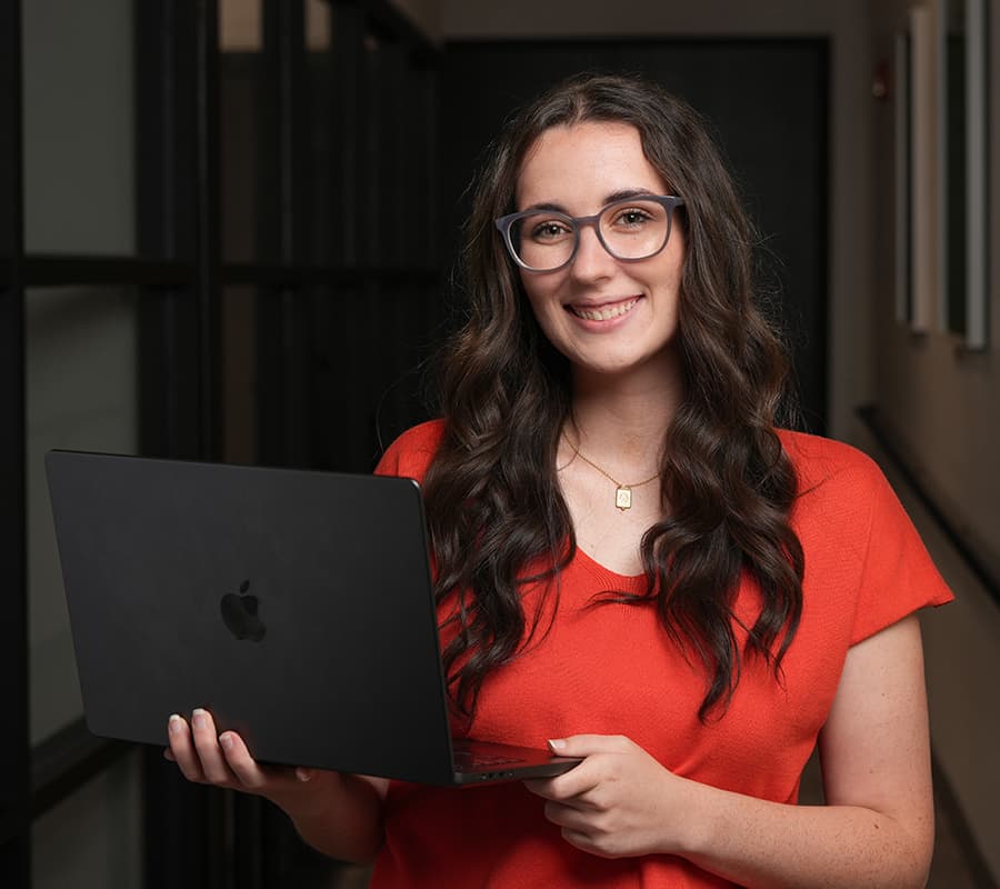 Sarah headshot holding a laptop